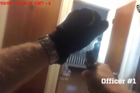 A still from the body camera footage showing an NYPD officer pointing his gun at Miguel Richards.